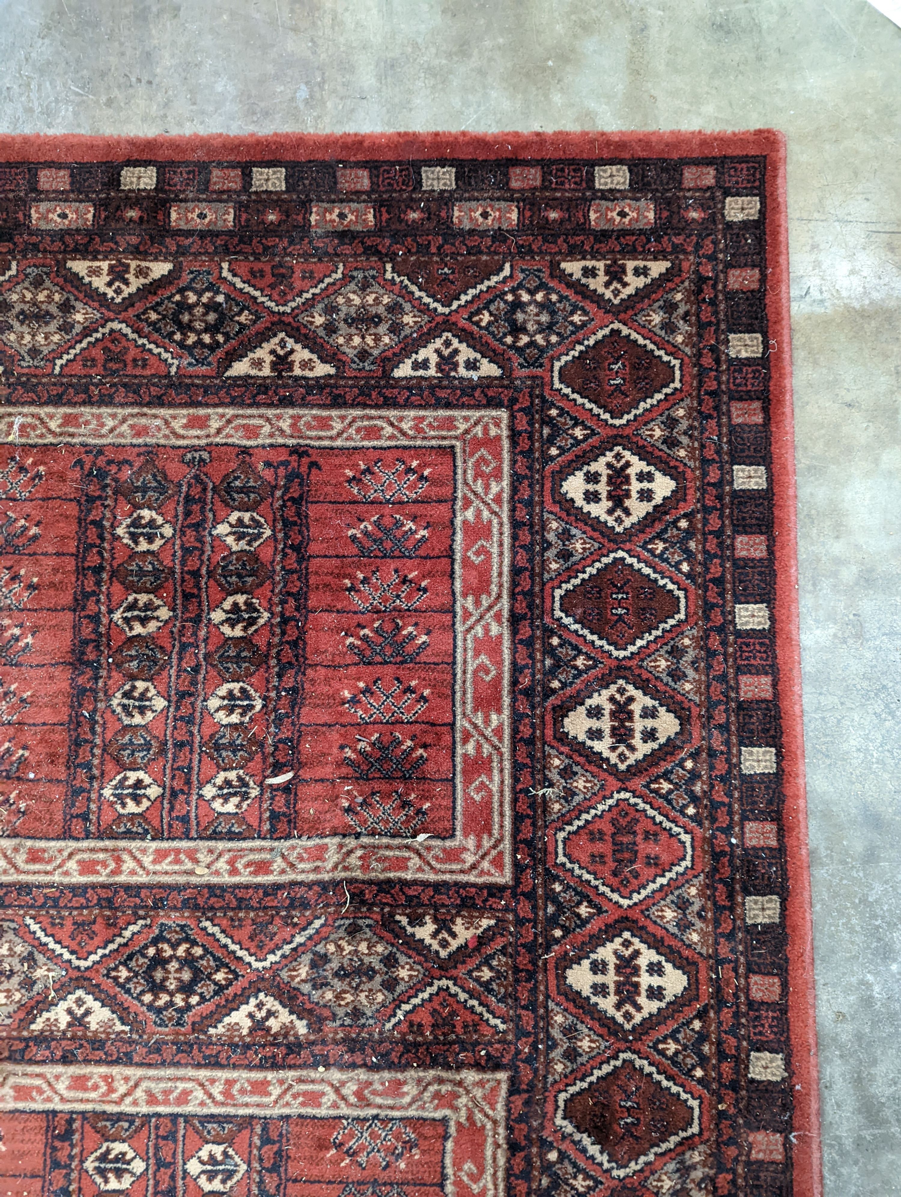 A Caucasian red ground rug, 190 x 136cm